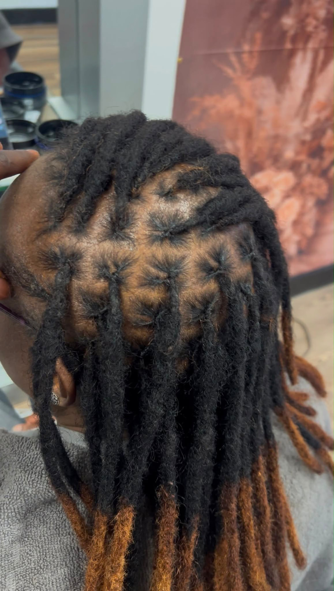 Real auburn-tipped loc retwist completed at Montana Beauty Empire