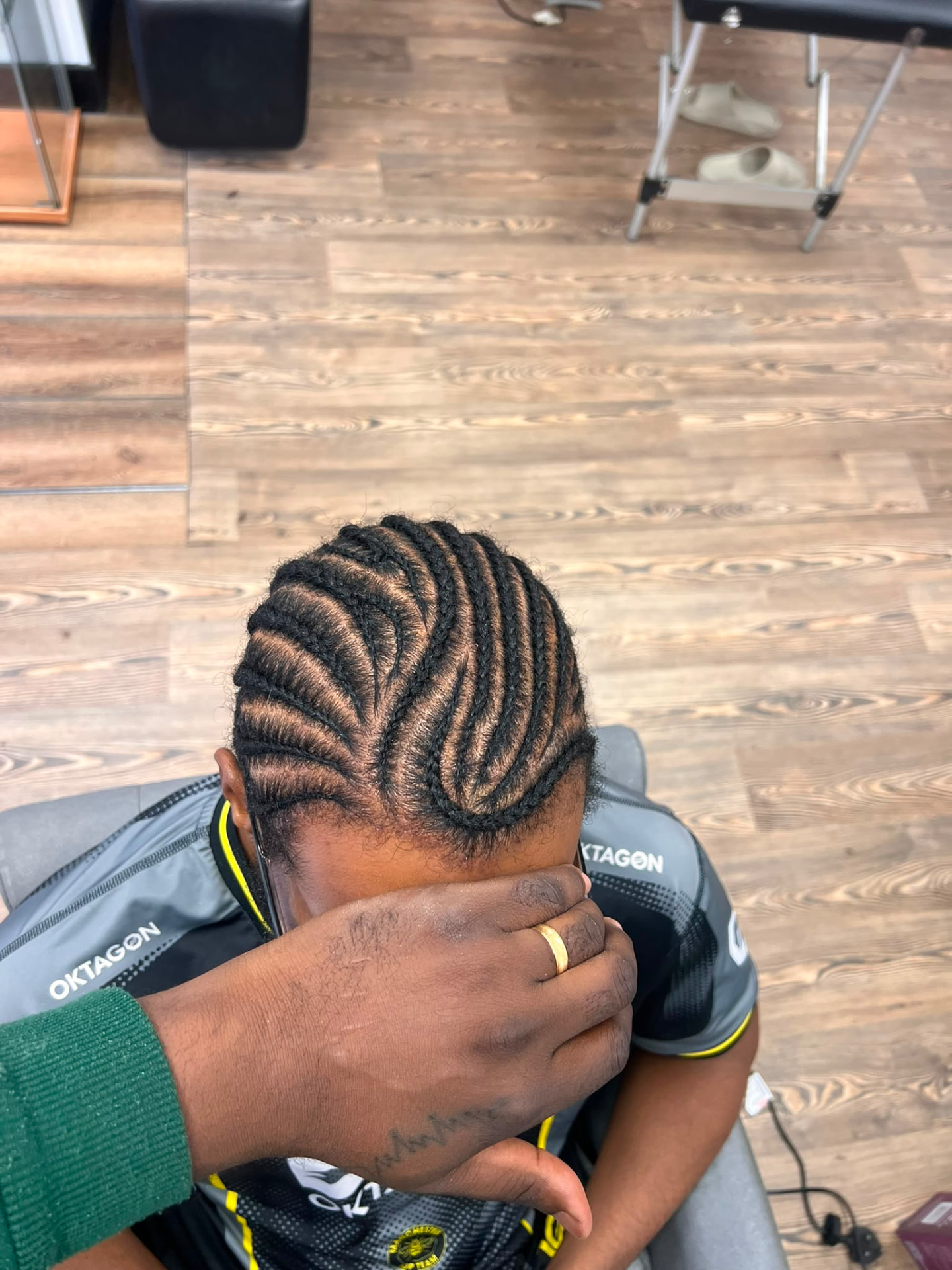 Curved cornrow braid design on a male client