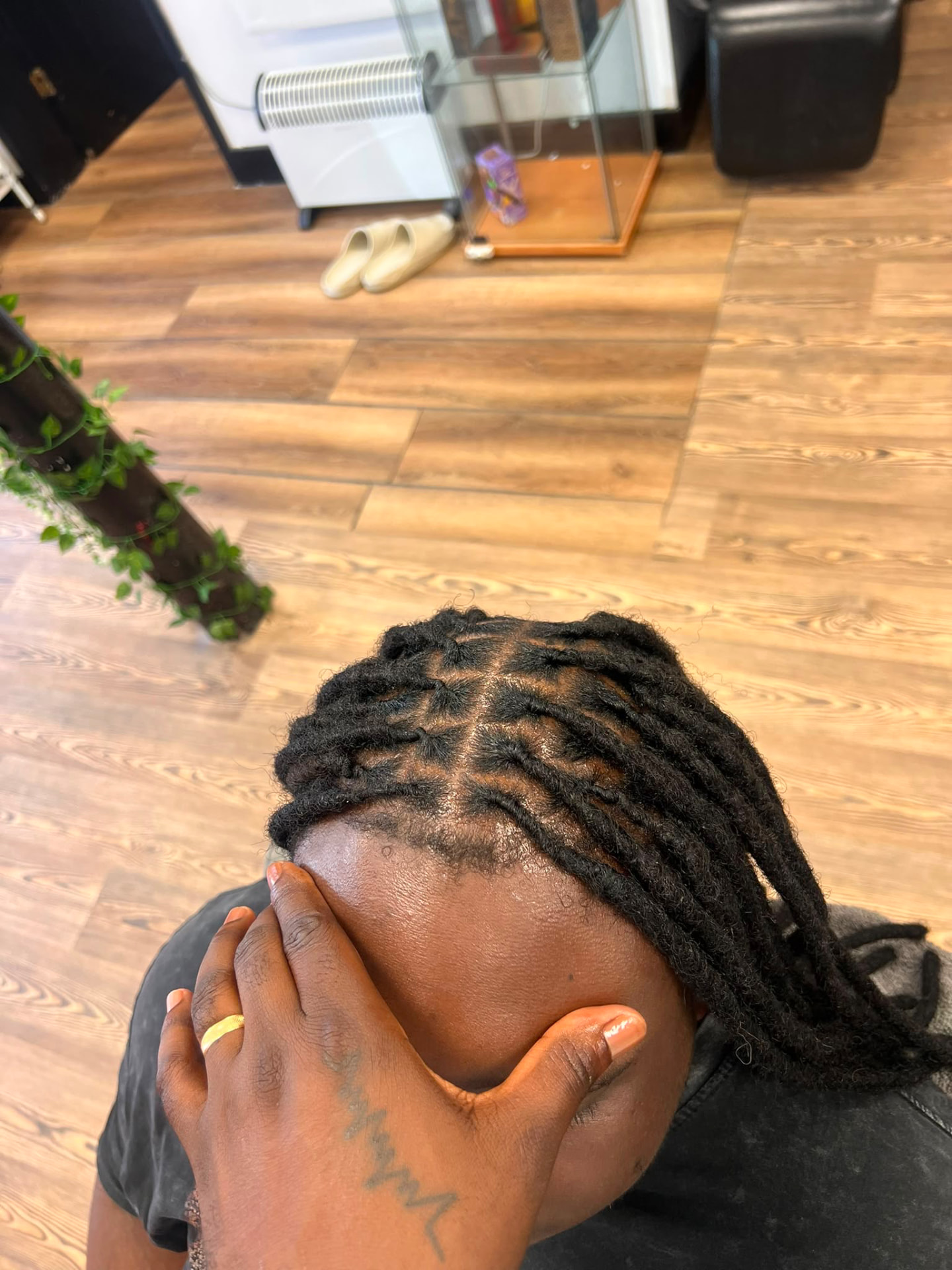 Fresh loc retwist swept to one side