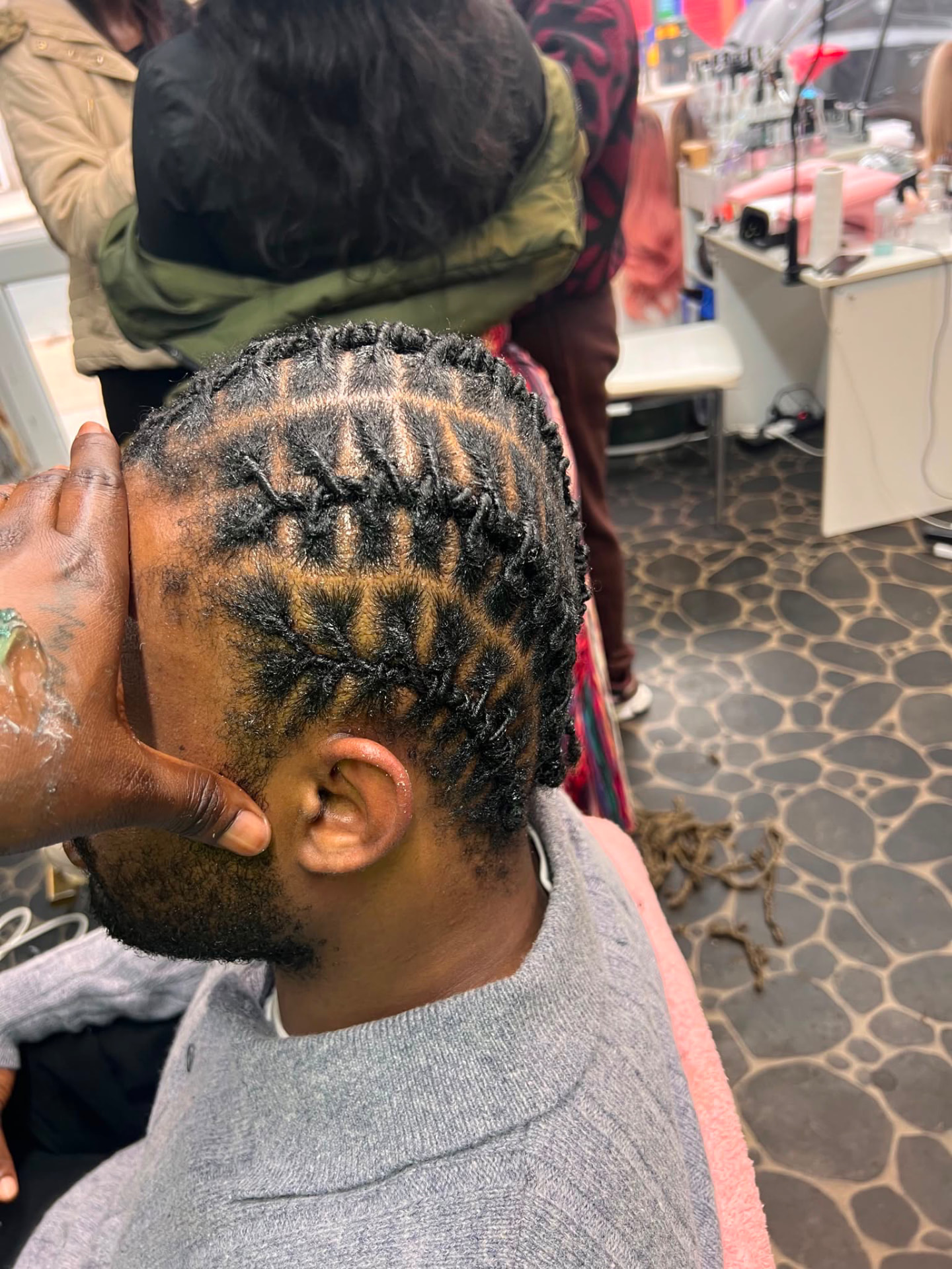 Detailed side cornrow style on a male client