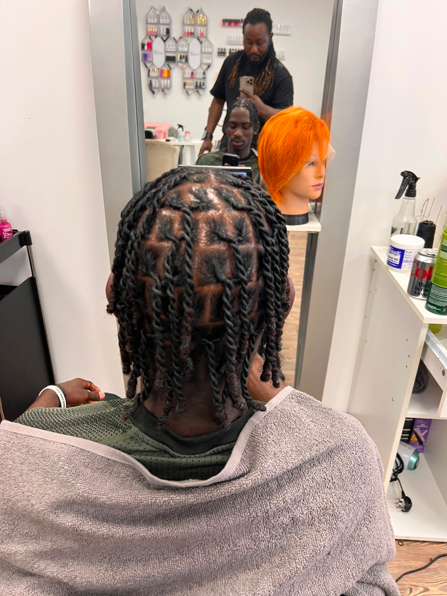 Two-strand loc retwist on a male client
